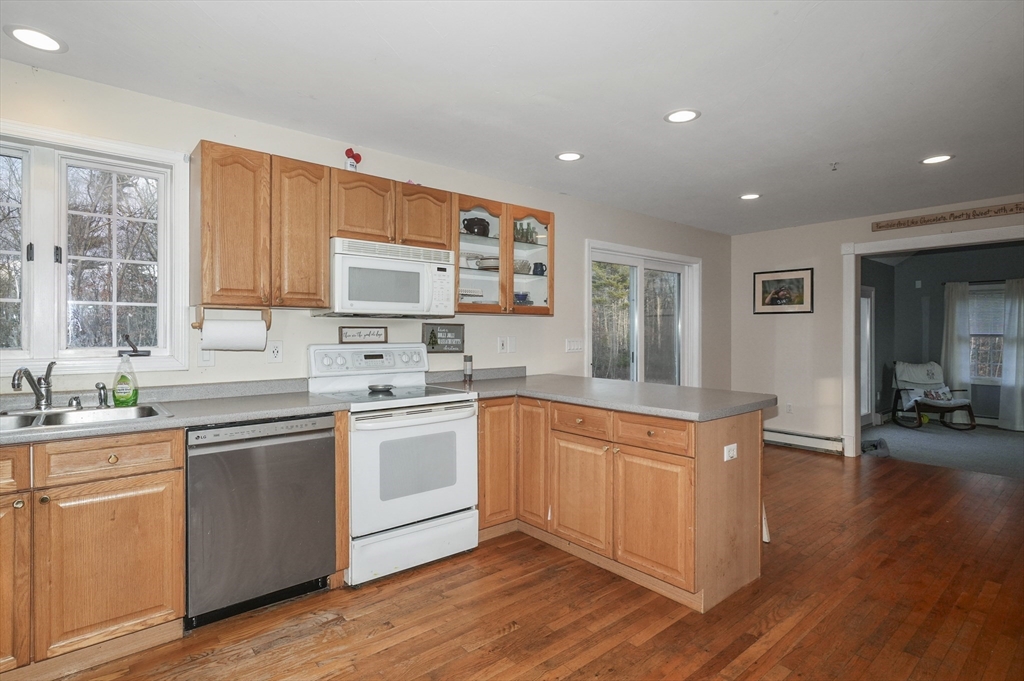 24 North End Road Townsend, MA 01469 - Photo 7 of 35 a kitchen with stainless steel appliances granite countertop a sink and cabinets