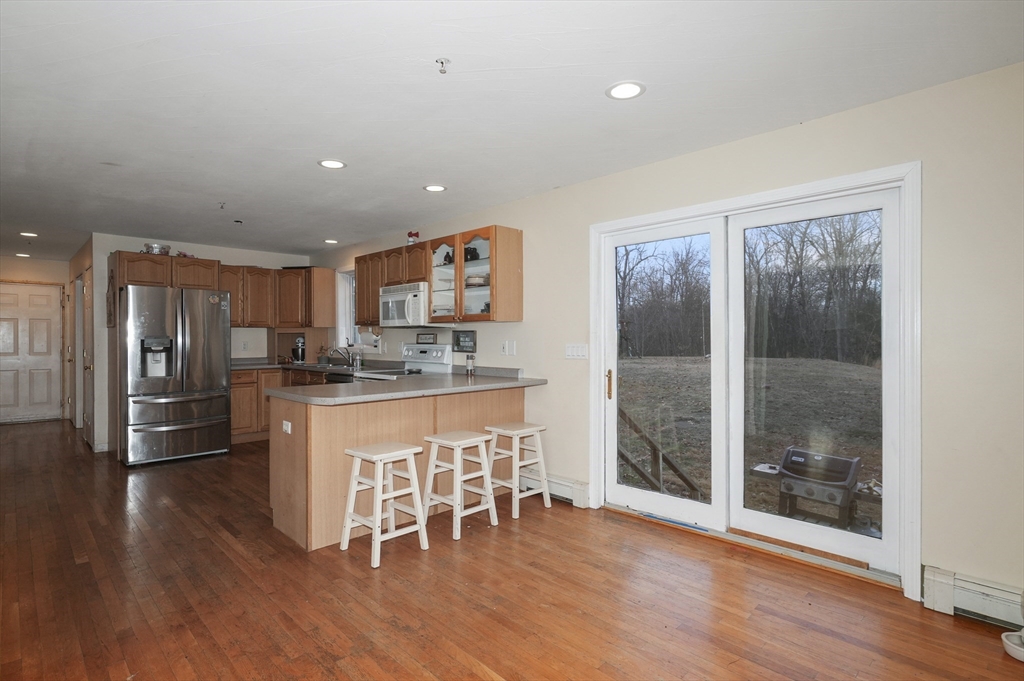 24 North End Road Townsend, MA 01469 - Photo 9 of 35 a kitchen with stainless steel appliances granite countertop a refrigerator and a stove top oven