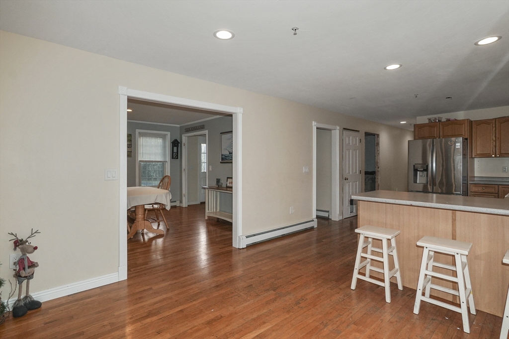 24 North End Road Townsend, MA 01469 - Photo 10 of 35 a view of kitchen with dining table chairs and wooden floor