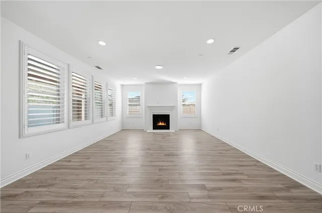 a large white kitchen with stainless steel appliances
