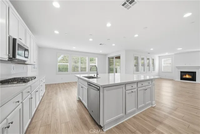 a kitchen with stainless steel appliances granite countertop a stove and a sink
