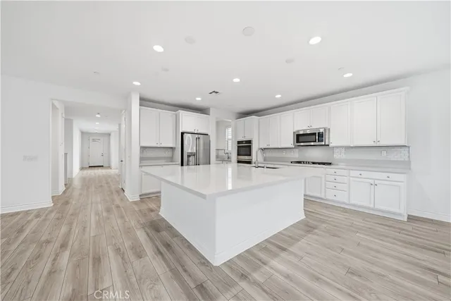 a spacious bathroom with a double vanity sink a mirror and a bathtub