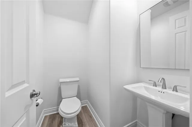 an empty room with windows and entrance to other room