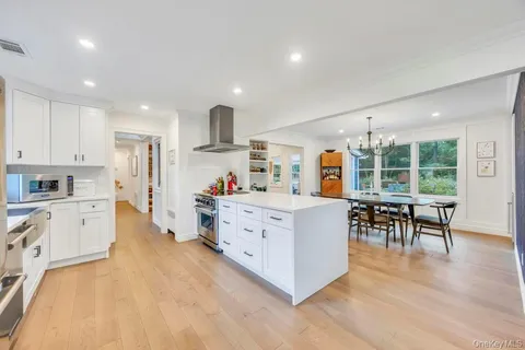 a kitchen with furniture and a wooden floor