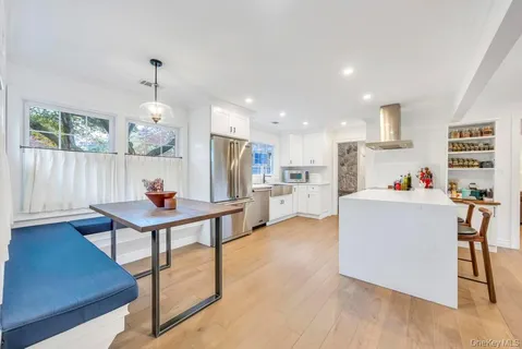 a living room with furniture and kitchen view
