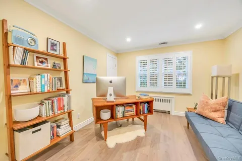 a living room with furniture and a book shelf