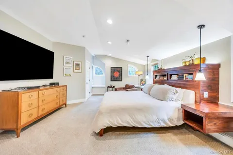 a bedroom with furniture and flat screen tv