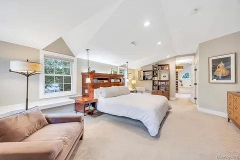 a bedroom with furniture and a large window