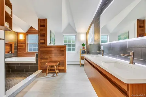 a spacious bathroom with a double vanity sink and a bathtub
