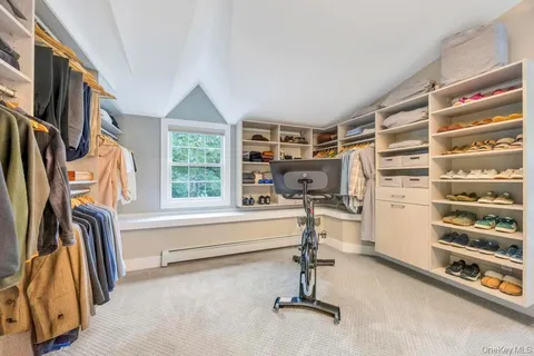 a view of walk in closet with clothes and shoes