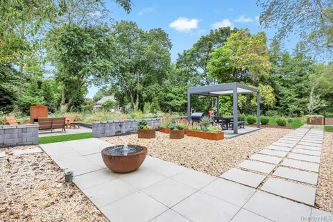 a view of a backyard with sitting area