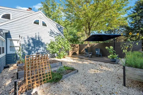 a view of house with backyard and sitting area