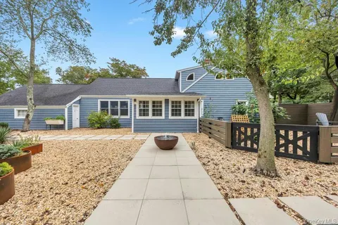 a view of a patio with a table chairs and a backyard