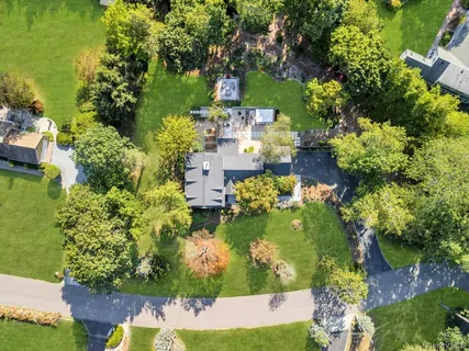 an aerial view of a house with a yard and lake view