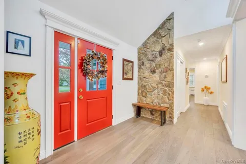 a view of an entryway with wooden floor