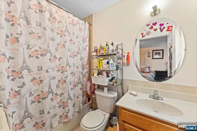 a bathroom with a sink mirror vanity and toilet