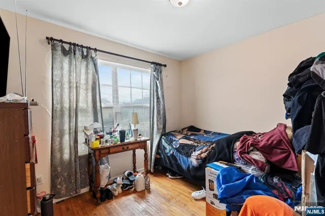 a bedroom with furniture and a window