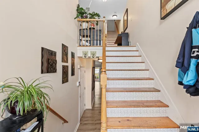 a view of entryway and hall with wooden floor