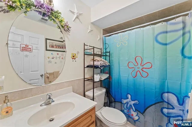 a bathroom with a sink mirror vanity and toilet
