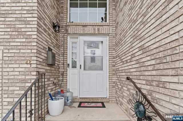 a view of house with potted plants