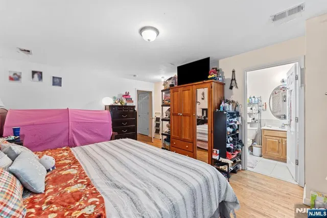 a bed room with a bed and dresser