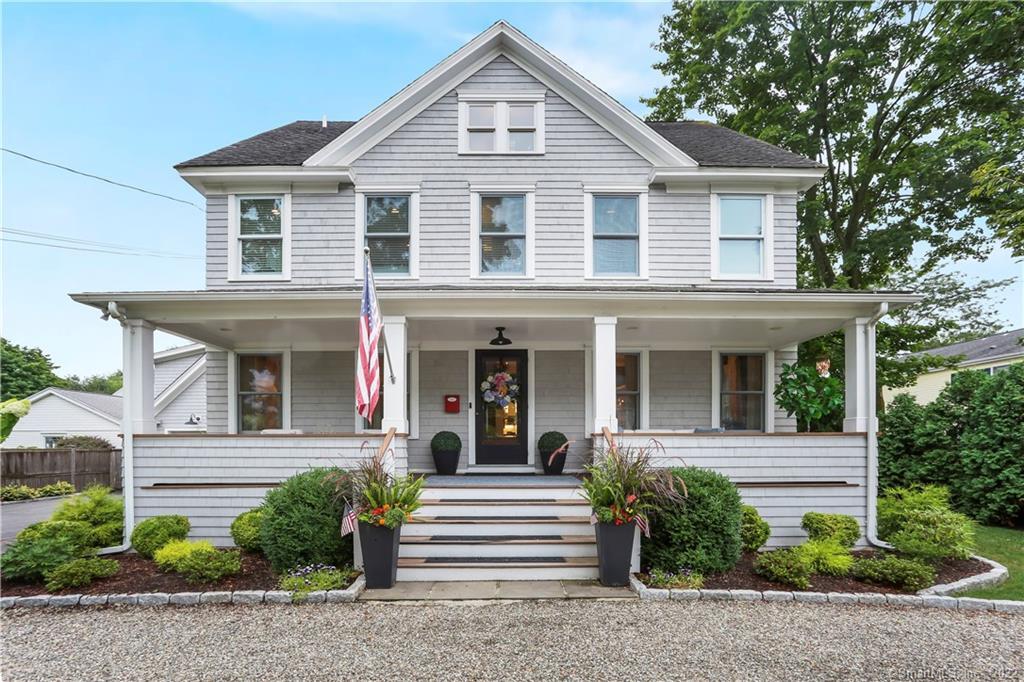 127 Oldfield Road Fairfield, CT 06824 - Photo 1 of 1 a view of a white house with large windows and plants