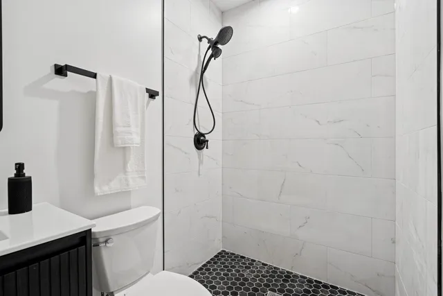 a bathroom with a shower toilet and sink