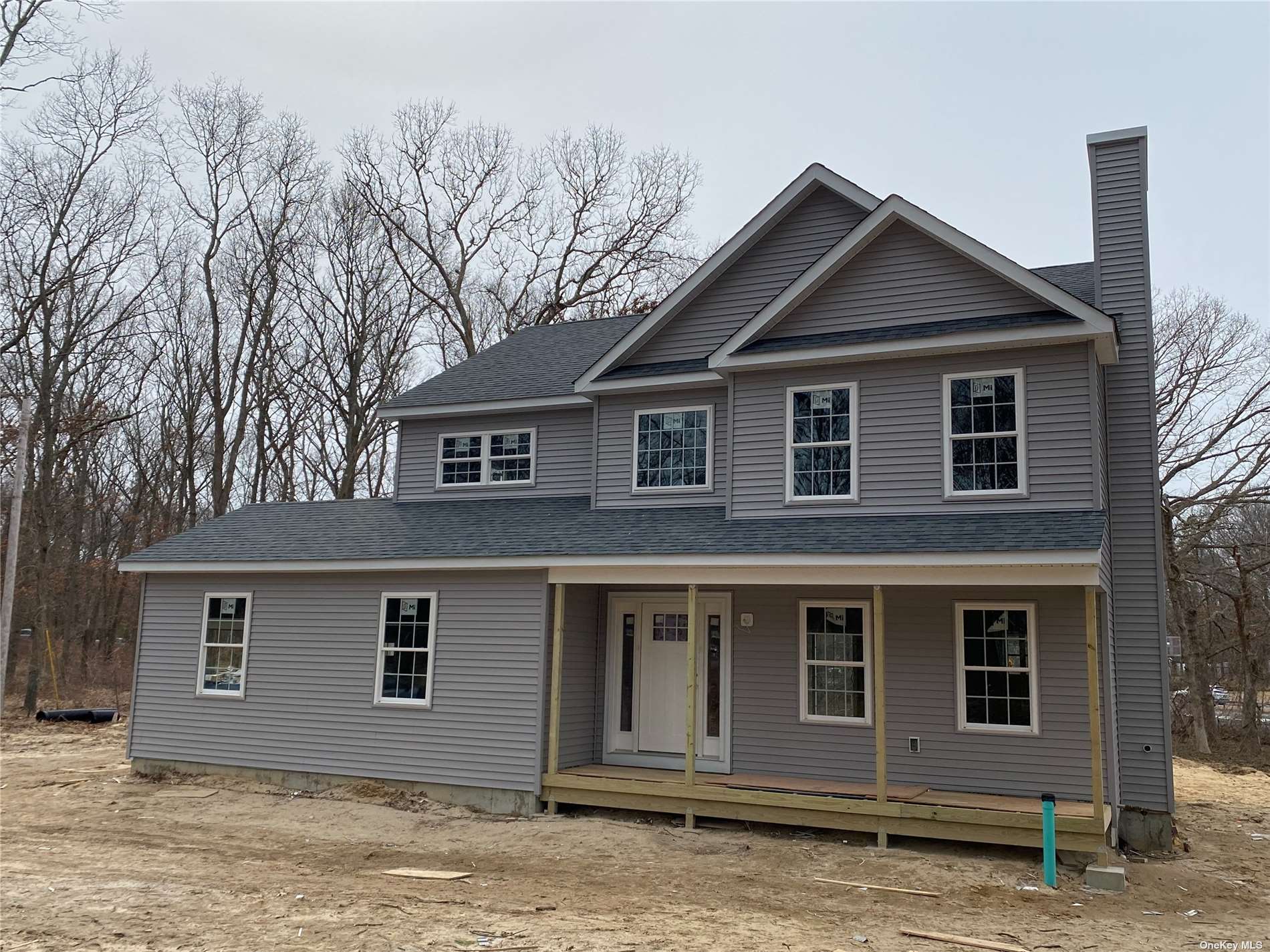 6 Dew Flag Road Ridge, NY 11961 - Photo 1 of 1 a front view of a house with a yard