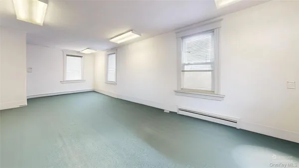 a living room with furniture and a dresser
