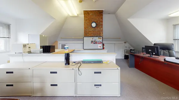 a dining room with furniture and a book shelf
