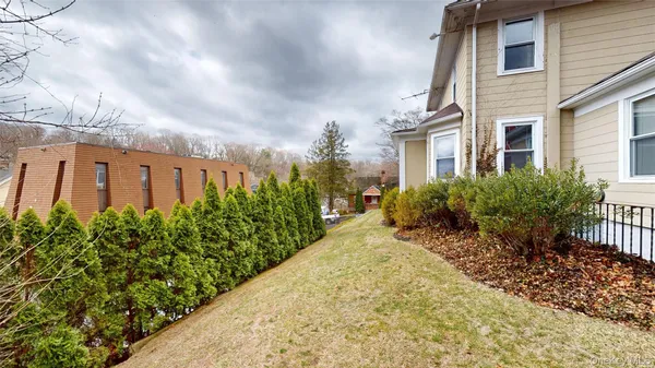 a view of a house with a yard and sitting area