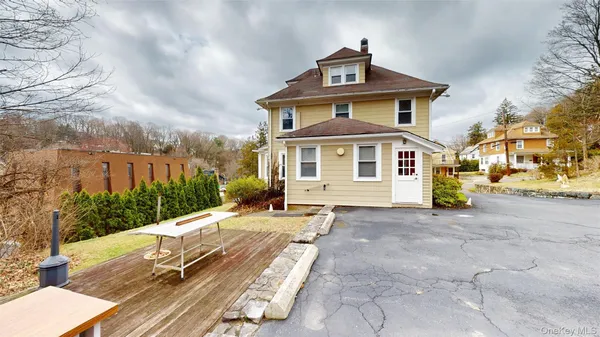 a view of a house with large windows and a small yard