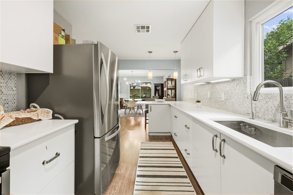 658 Mairo Street Austin, TX 78748 - Photo 12 of 40 Streamlined kitchen design with abundant counter space and integrated appliances for modern living.