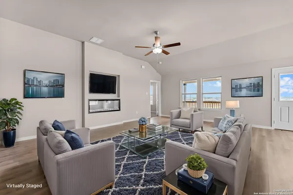 a living room with furniture a window and a flat screen tv