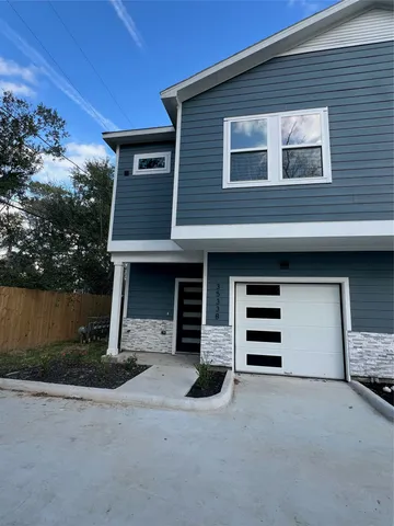 a front view of a house with garage