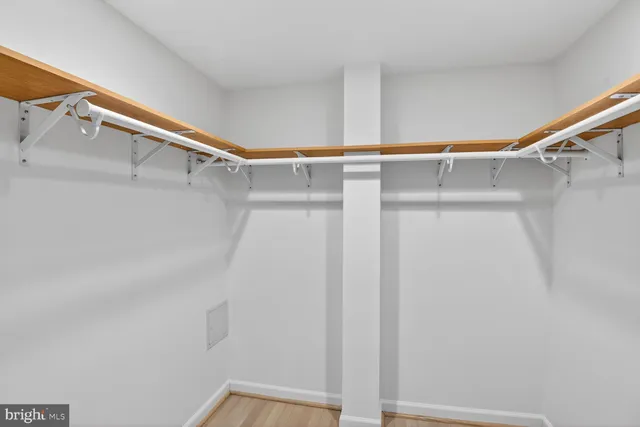 a view of walk in closet with clothes