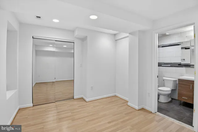 a view of a room with wooden floor and sink