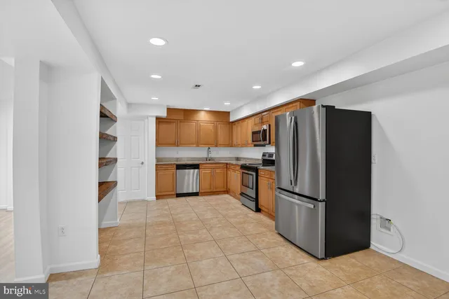 a kitchen with stainless steel appliances a refrigerator and a sink
