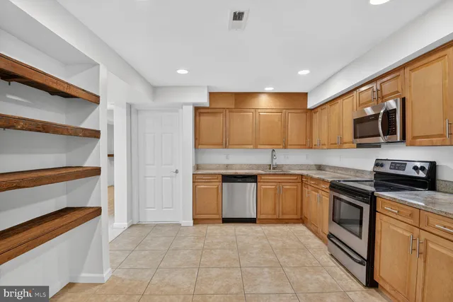 a kitchen with stainless steel appliances granite countertop a stove and a sink
