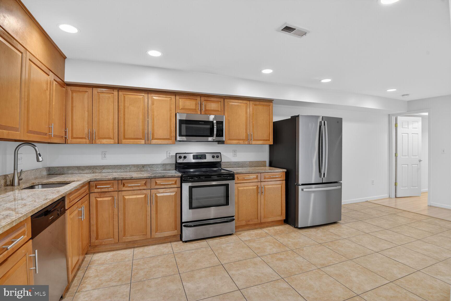 424 Q Street Northwest, Unit A Washington, DC 20001 - Photo 8 of 15 a kitchen with stainless steel appliances granite countertop a refrigerator sink and stove