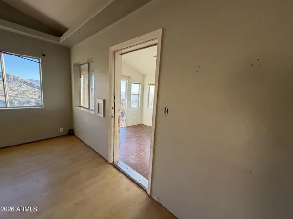 an empty room with windows and closet