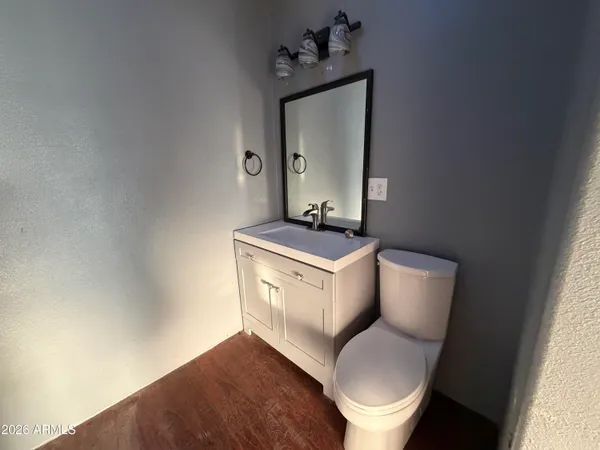 a white toilet sitting next to a bathroom sink