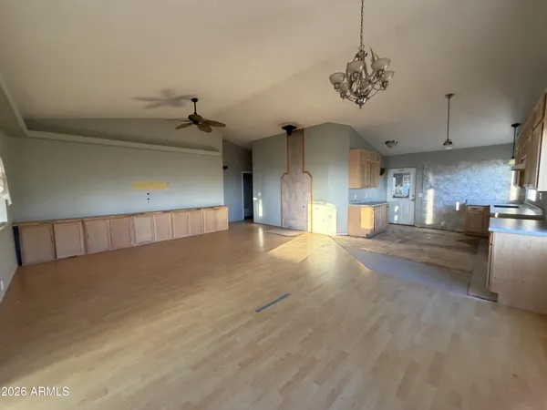 a view of a room with lots of wooden furniture and windows