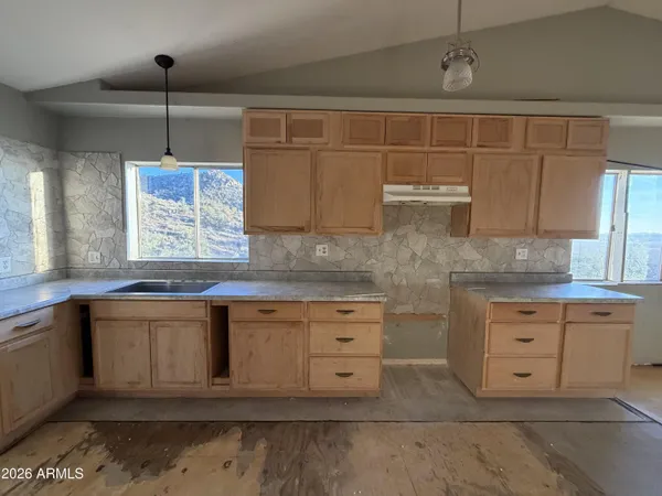 a kitchen with stainless steel appliances granite countertop a sink and cabinets