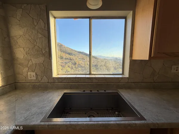 a kitchen with a sink and a window