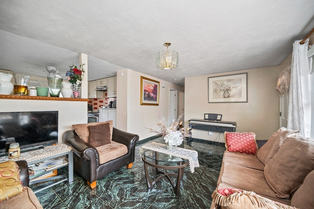 12 Dodge Road Brockton, MA 02302 - Photo 3 of 18 a living room with furniture and a flat screen tv