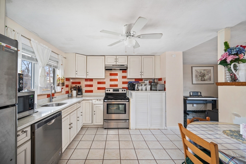 12 Dodge Road Brockton, MA 02302 - Photo 5 of 18 a kitchen with stainless steel appliances a stove refrigerator sink and cabinets