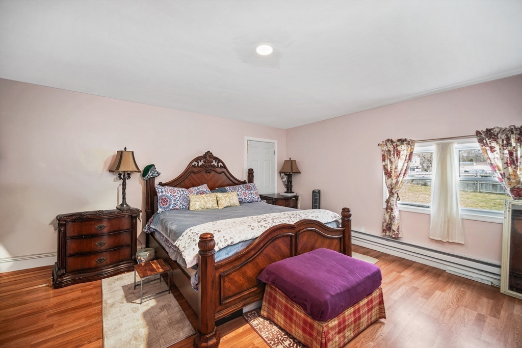 12 Dodge Road Brockton, MA 02302 - Photo 10 of 18 a bedroom with a bed and wooden floor