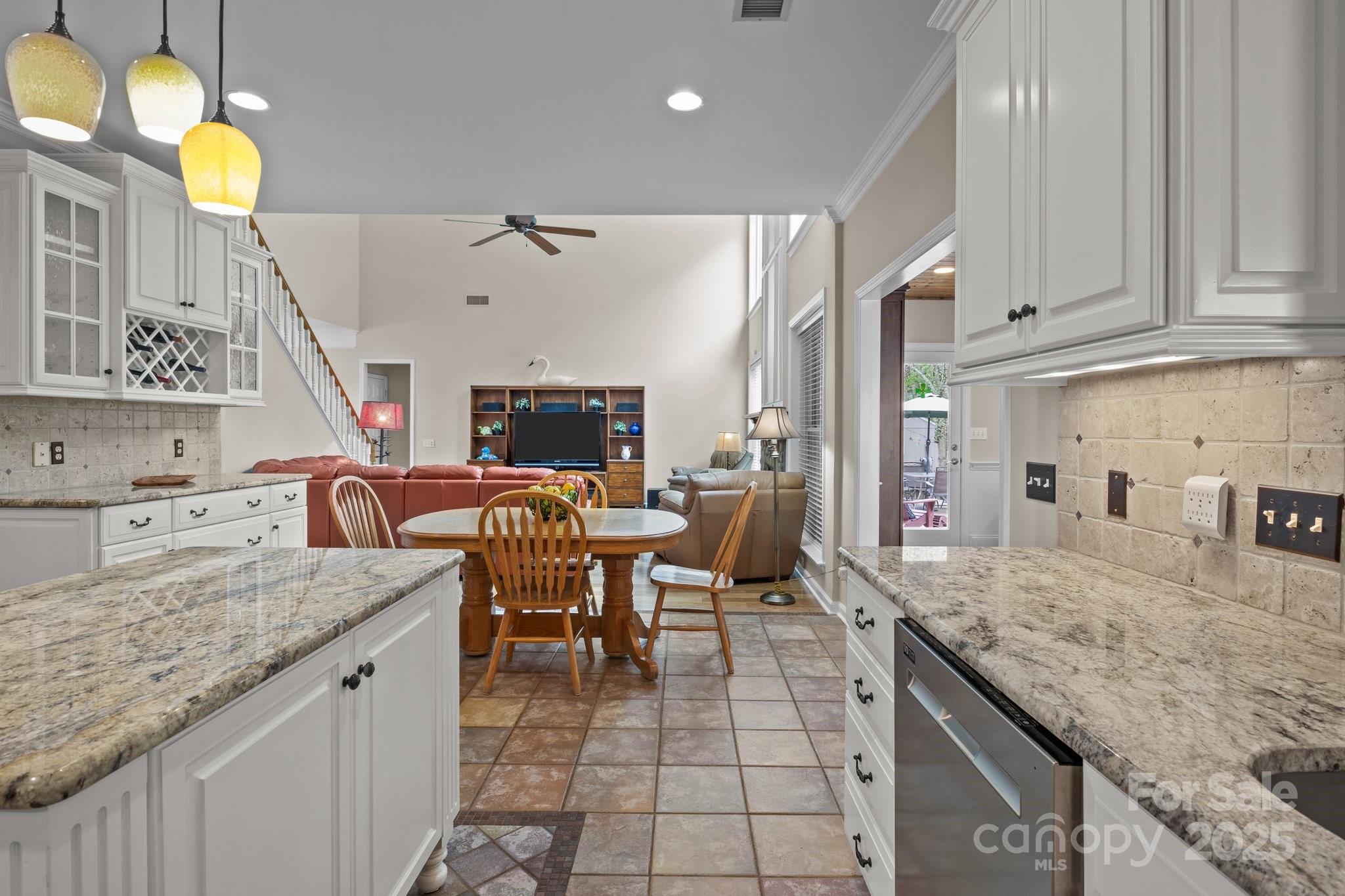 7710 Epping Forest Drive Huntersville, NC 28078 - Photo 11 of 37 a kitchen with granite countertop a sink a stove and cabinets