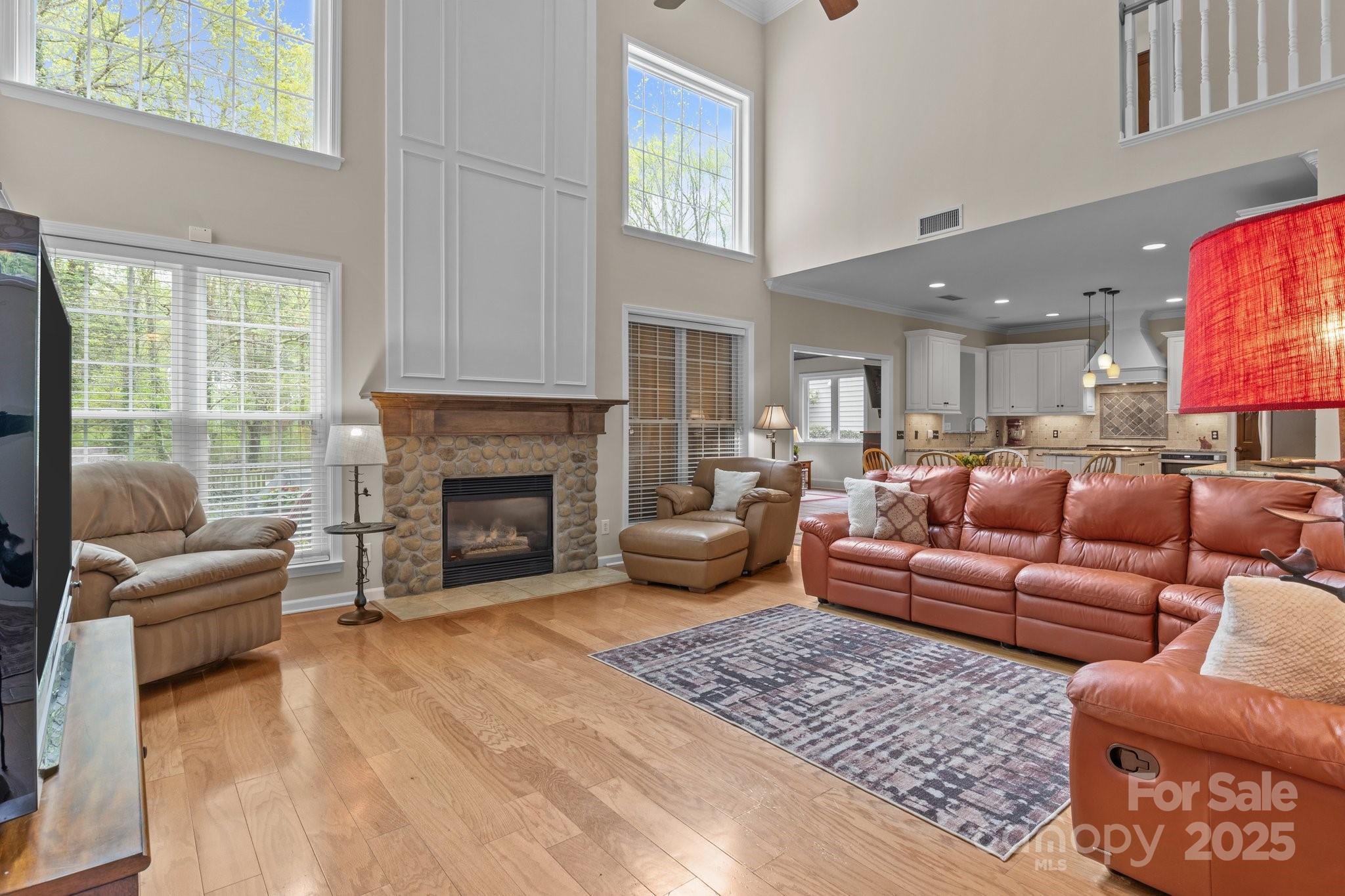 7710 Epping Forest Drive Huntersville, NC 28078 - Photo 15 of 37 a living room with furniture a window and a fireplace